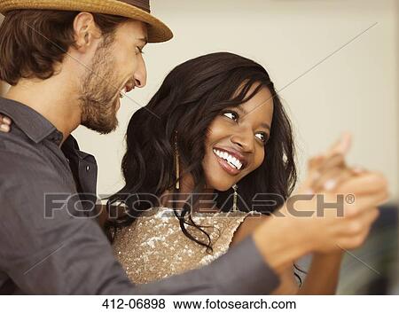 Stock Photo - Couple dancing together indoors. Fotosearch