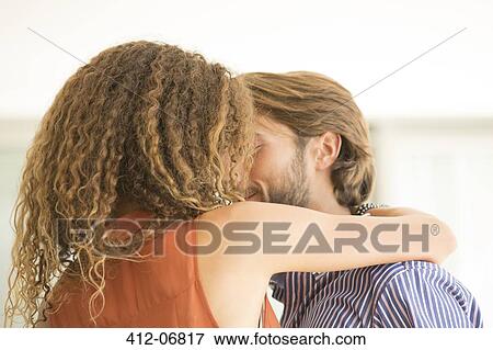 Couple kissing indoors View Large Photo Image Stock Photo - Couple kissing indoors. Fotosearch