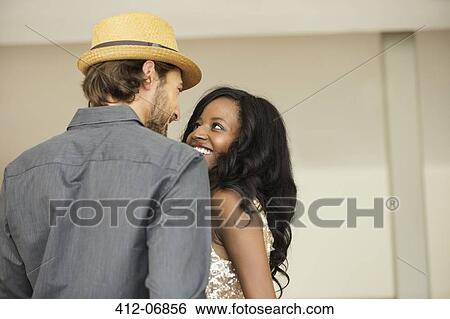 Couple smiling together indoors View Large Photo Image Stock Photograph - Couple smiling together indoors. Fotosearch
