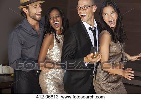 Stock Image - Friends dancing at party. Fotosearch