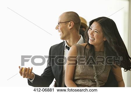 Stock Image - Friends dancing at party. Fotosearch