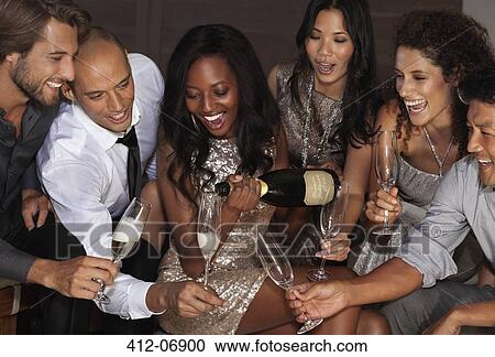 Friends drinking champagne at party View Large Photo Image Stock Image - Friends drinking champagne at party. Fotosearch