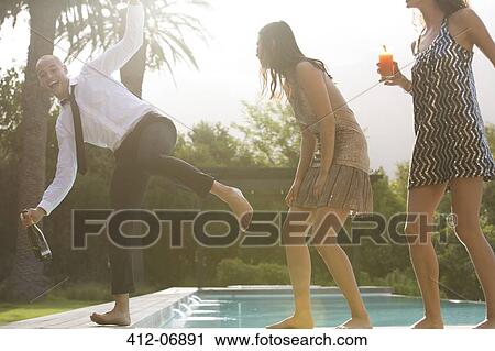 Friends having drinks by swimming pool View Large Photo Image Stock Image - Friends having drinks by swimming pool. Fotosearch