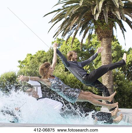 Friends jumping backwards into swimming pool View Large Photo Image Stock Photography - Friends jumping backwards into swimming pool. Fotosearch