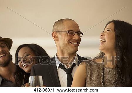 Friends laughing at party View Large Photo Image Stock Image - Friends laughing at party. Fotosearch