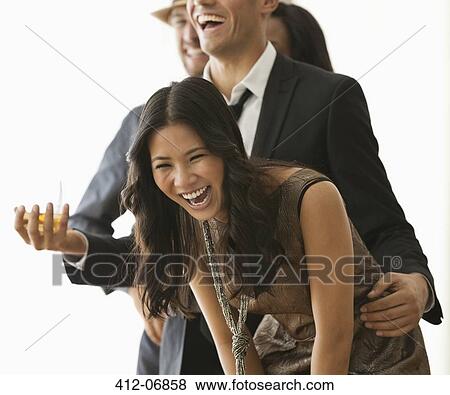 Stock Photo - Friends laughing at party. Fotosearch