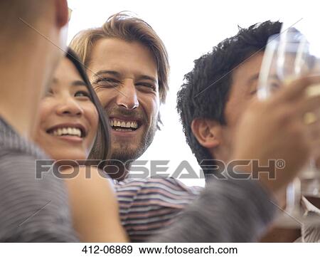 Friends laughing at party View Large Photo Image Stock Photo - Friends laughing at party. Fotosearch