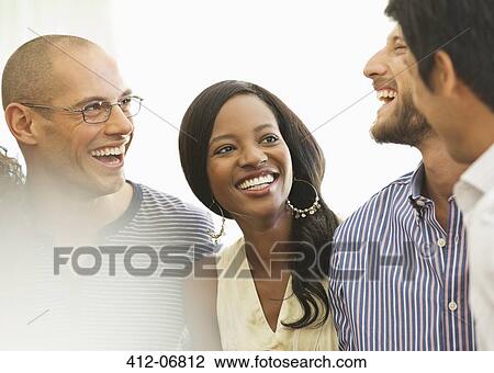 Friends laughing together indoors View Large Photo Image Stock Image - Friends laughing together indoors. Fotosearch