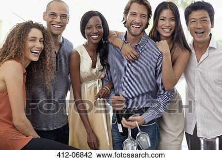Stock Image - Friends smiling together at party. Fotosearch
