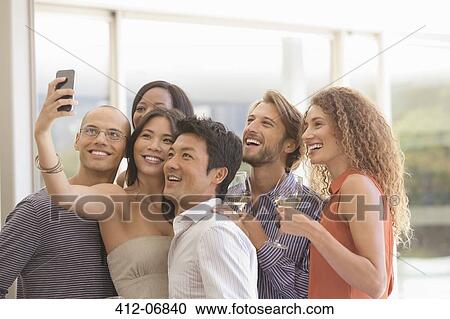 Stock Image - Friends taking picture together. Fotosearch