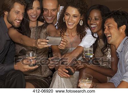 Stock Image - Friends taking picture together. Fotosearch