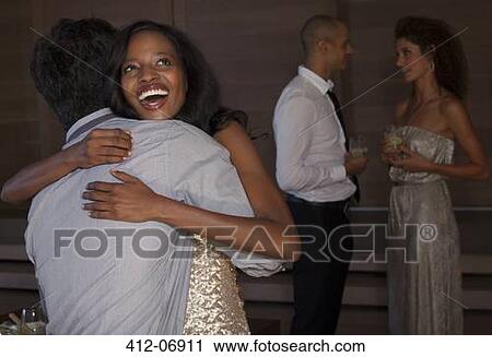 Stock Image - Friends talking at party. Fotosearch