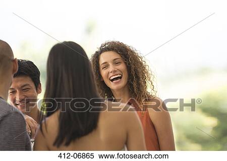 Stock Photography - Friends talking at party. Fotosearch