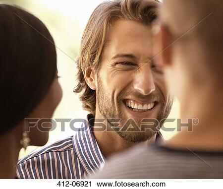Friends talking outdoors View Large Photo Image Stock Image - Friends talking outdoors. Fotosearch