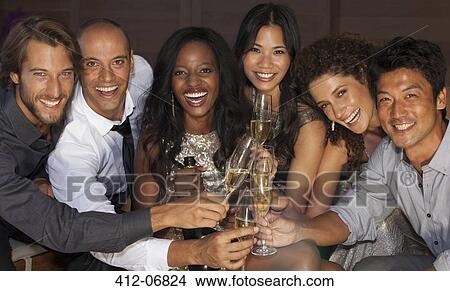 Picture - Friends toasting each other at party. Fotosearch
