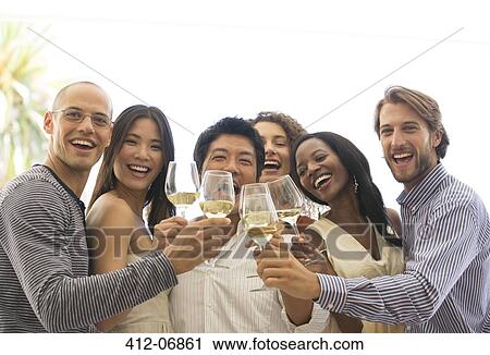 Friends toasting each other at party View Large Photo Image Stock Image - Friends toasting each other at party. Fotosearch