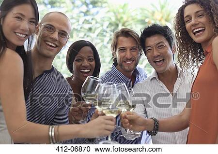 Friends toasting each other at party View Large Photo Image Stock Image - Friends toasting each other at party. Fotosearch
