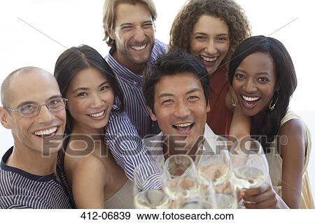 Friends toasting each other at party View Large Photo Image Stock Photo - Friends toasting each other at party. Fotosearch