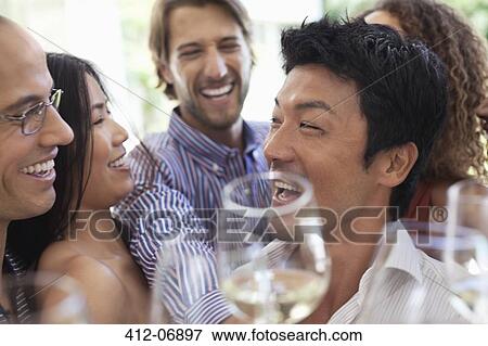 Friends toasting each other at party View Large Photo Image Stock Photo - Friends toasting each other at party. Fotosearch