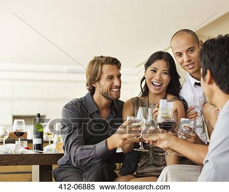 Stock Photography - Friends toasting each other at party. Fotosearch