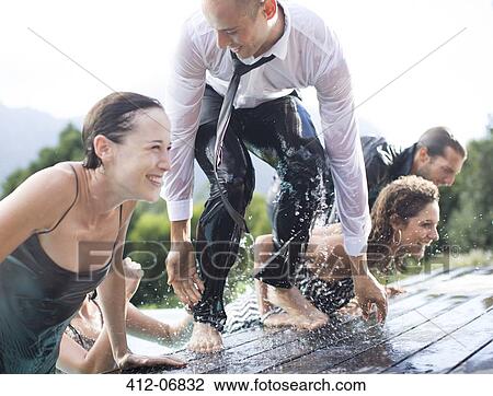 Fully dressed friends climbing out of swimming pool View Large Photo Image Stock Image - Fully dressed friends climbing out of swimming pool. Fotosearch