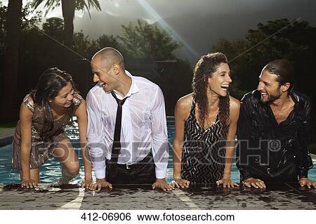 Fully dressed friends climbing out of swimming pool View Large Photo Image Stock Photograph - Fully dressed friends climbing out of swimming pool. Fotosearch