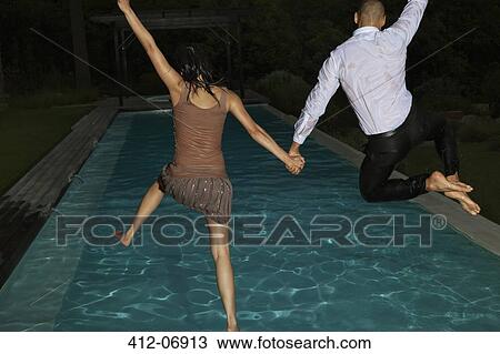 Fully dressed friends jumping into swimming pool View Large Photo Image Stock Image - Fully dressed friends jumping into swimming pool. Fotosearch
