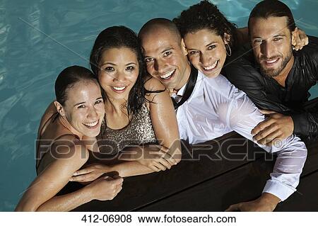 Fully dressed friends smiling in swimming pool View Large Photo Image Stock Photo - Fully dressed friends smiling in swimming pool. Fotosearch