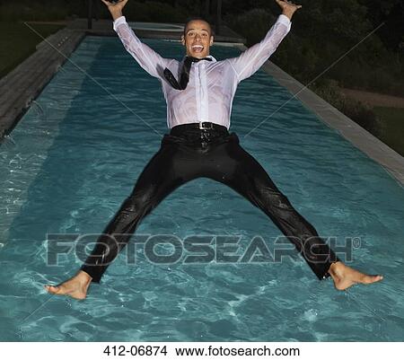 Fully dressed man jumping into swimming pool View Large Photo Image Picture - Fully dressed man jumping into swimming pool. Fotosearch