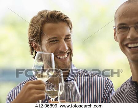 Men drinking wine together indoors View Large Photo Image Stock Photo - Men drinking wine together indoors. Fotosearch