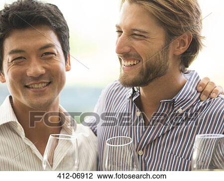 Smiling men hugging outdoors View Large Photo Image Stock Image - Smiling men hugging outdoors. Fotosearch