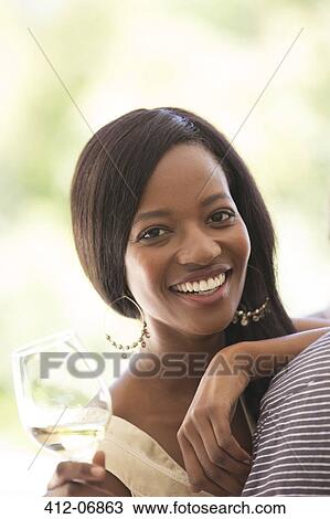 Smiling woman having glass of wine View Large Photo Image Stock Image - Smiling woman having glass of wine. Fotosearch