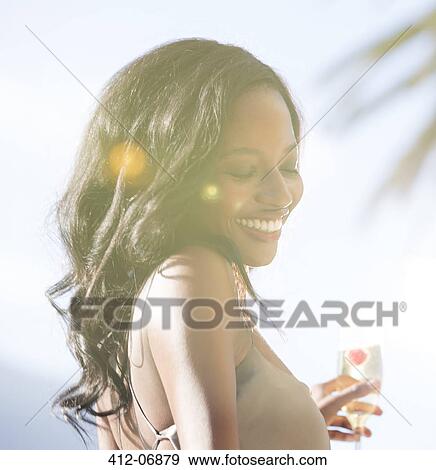 Stock Photo - Smiling woman standing outdoors. Fotosearch