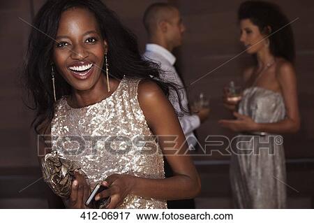 Stock Photo - Smiling woman wearing evening gown. Fotosearch