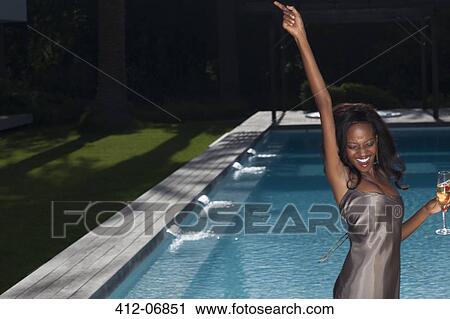 Woman dancing by swimming pool at party View Large Photo Image Stock Image - Woman dancing by swimming pool at party . Fotosearch