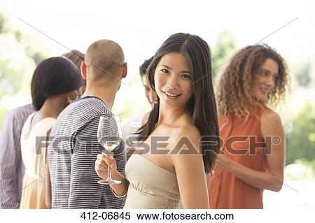 Woman having glass of wine at party View Large Photo Image Stock Photography - Woman having glass of wine at party. Fotosearch