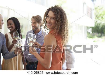 Stock Photography - Woman smiling at party. Fotosearch