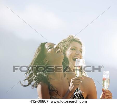 Women drinking champagne together outdoors View Large Photo Image Stock Photo - Women drinking champagne together outdoors. Fotosearch