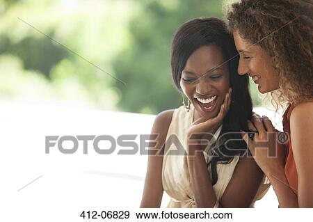 Women laughing together outdoors View Large Photo Image Stock Photo - Women laughing together outdoors. Fotosearch