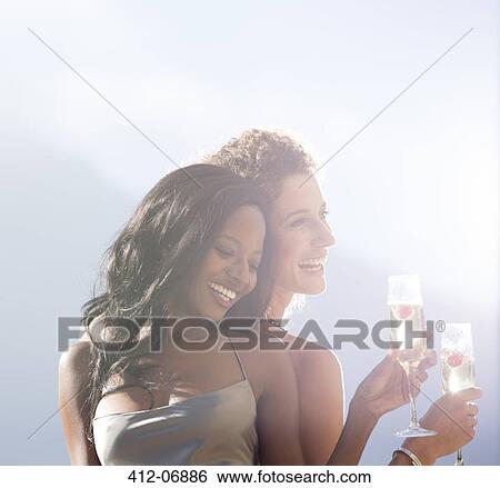 Stock Photograph - Women smiling together outdoors. Fotosearch