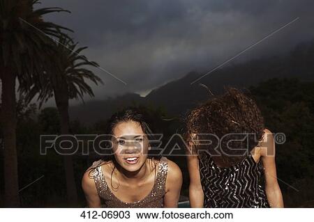 Women standing outside in storm View Large Photo Image Stock Image - Women standing outside in storm. Fotosearch