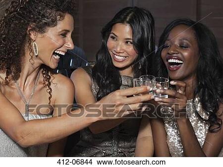 Picture - Women toasting each other at party. Fotosearch