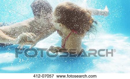 Stock Photo - Couple kissing in swimming pool. Fotosearch