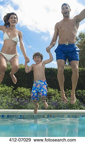 Stock Photo - Family jumping into swimming pool. Fotosearch
