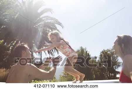 Family playing in swimming pool View Large Photo Image Stock Image - Family playing in swimming pool. Fotosearch