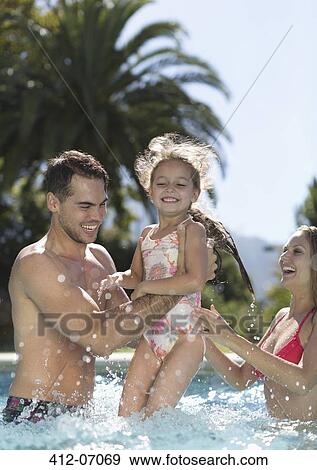 Stock Photo - Family playing in swimming pool. Fotosearch