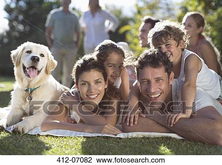 Stock Image - Family relaxing in backyard. Fotosearch