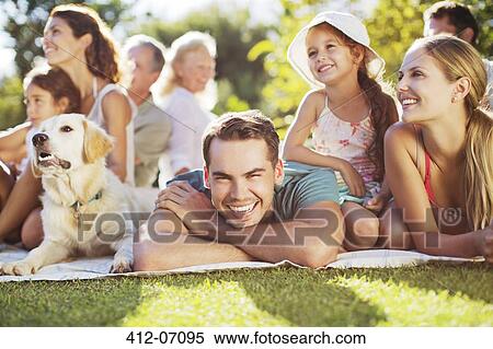 Family relaxing in backyard View Large Photo Image Stock Photography - Family relaxing in backyard. Fotosearch