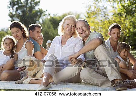 Stock Photograph - Family relaxing together in backyard. Fotosearch
