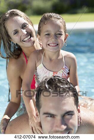 Family smiling in swimming pool View Large Photo Image Picture - Family smiling in swimming pool. Fotosearch